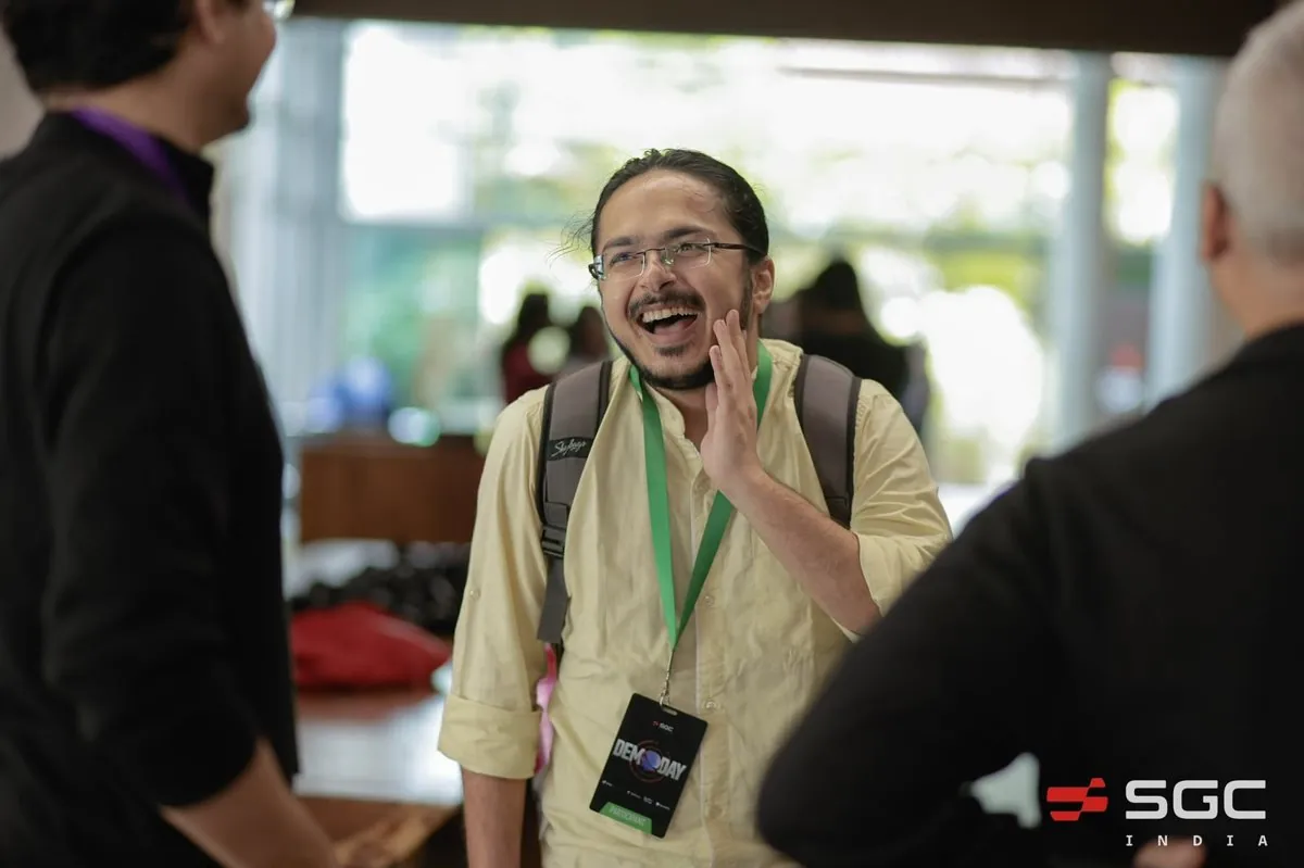 A participant laughing in conversation at Demo Day