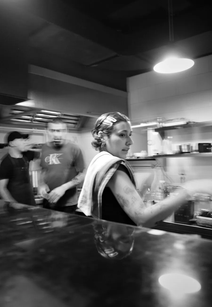 Black and white photo of the kitchen mid-service